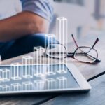 Businessman analyzing growing 3D AR chart above tablet computer screen